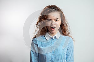 Screeming teenager wearing white and blue shirt photo