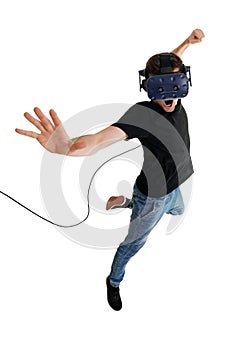 Screeming young man isolated on white background playing game in virtual reality glasses