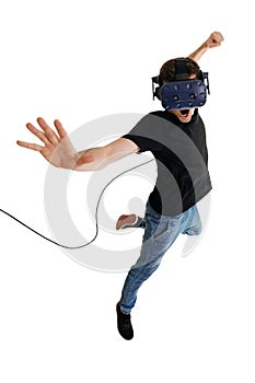 Screeming young man isolated on white background playing game in virtual reality glasses photo