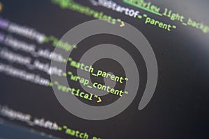 Screen of android application developing code. Lines of code on computer screen background