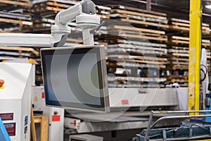 Screen attached to computerised machinery in a factory photo