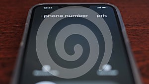 Screen incoming call from an unknown number on a black background.