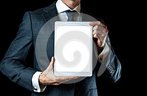 Screen mockup. Empty blank tablet in businessman hand. Mock up screen smart device isolated on black banner background