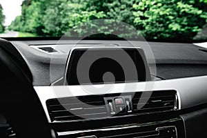 Screen multimedia system on dashboard in a modern car.