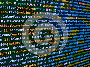 Screen of web developing code on dark background. Software developer programming code on computer. Simple website HTML code with