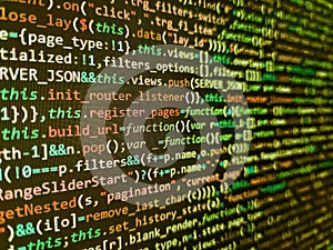 Screen of web developing php code on dark background. Programmer working in a software develop company office. Web programming and