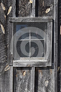 Screened mesh over window of an old building