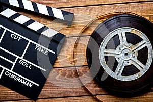 Screenwriter desktop with movie clapper board wooden background