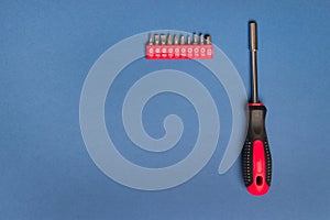 Screw-driver with nozzles on a blue background, with copy space top view