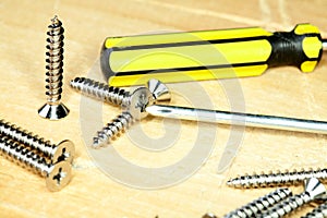 Screw-driver screws on a board