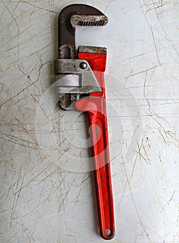 Screw-wrench on a metal background photo