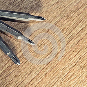Screwdrive replaceable bits on a wooden background