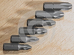 Screwdrive replaceable bits on a wooden background