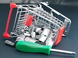 Screwdriver with interchangeable heads in toppled shopping cart