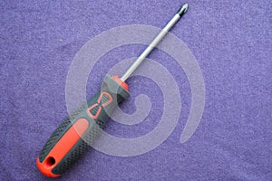 Screwdriver with rubberized red-black handle and black tip