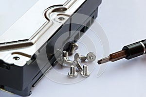 Screwdriver and screws near hard drive