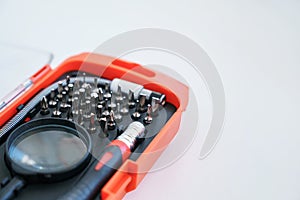 Screwdriver with a set of bits for accurate work with a magnifying glass