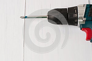 Screwdriver on a wooden background with the Mets to insert text. The concept of construction, repair, improvement of housing