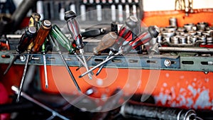 Screwdrivers and other work tools on workbench in garage