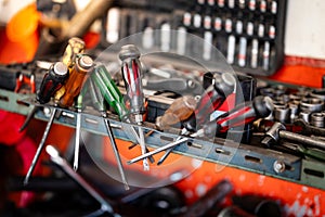 Screwdrivers and other work tools on workbench in garage