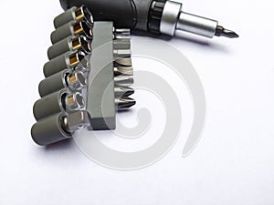 Screwdrivers  on white background. Interchangeable screwdriver set with different types of metal, steel heads and bits.