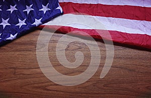 Screwed Up USA Flag on Brown Wooden Board Background