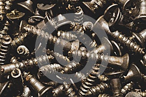 Screws background. heap of tapping screws. pile of fasteners