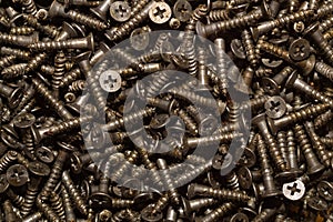 Screws background. heap of tapping screws. pile of fasteners