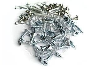 screws, bolts, nails and different type of metal on white background