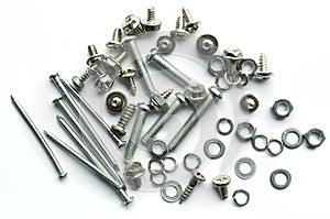 Screws, bolts, nails on white background