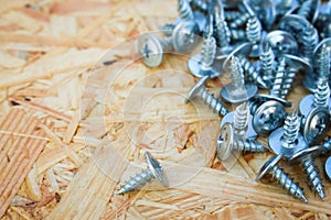 Screws closeup on wooden background