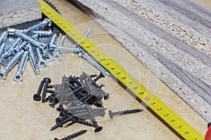 Screws, confirmations for furniture, are on the table. Furniture production photo