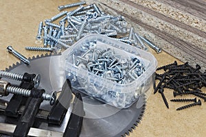 Screws, confirmations for furniture, tape measure, clamp, lie on the table. Furniture production photo