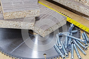 Screws, confirmations for furniture, tape measure, lie on the table. Furniture production photo