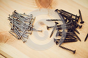 Screws, nails, bolts srt on the wooden table photo