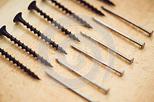 Screws, nails, bolts srt on the wooden table photo