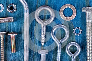 Screws nuts and washers of different types and measures on blue
