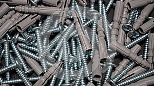 Screws and plastic dowels texture background