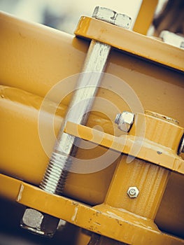 Screws on steel big machinery closeup