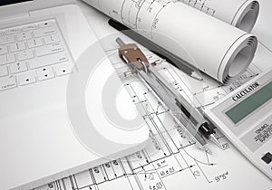 Scrolls engineering drawings and laptop