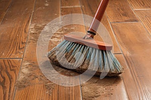 scrub brush on dirty floor before cleaning progress