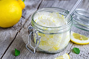 Scrub made of sea salt, lemon peel and lemon juice photo