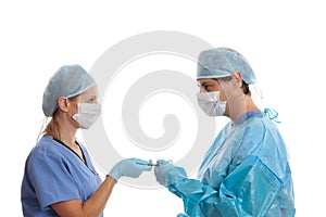 Scrub nurse handing surgeon forceps