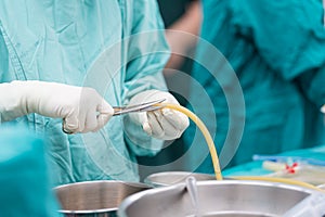 Scrub nurse preparing chest drain for open heart surgery