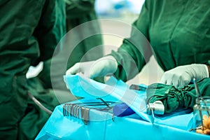 Scrub nurse preparing medical instruments for operation