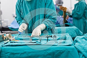 Scrub nurse preparing medical instruments for operation