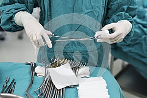 Scrub nurse preparing medical instruments for operation