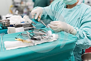 Scrub nurse preparing medical instruments for operation