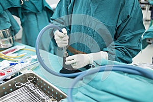 Scrub nurse preparing medical instruments for surgery