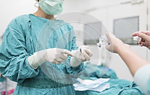 Scrub nurse preparing medical solution